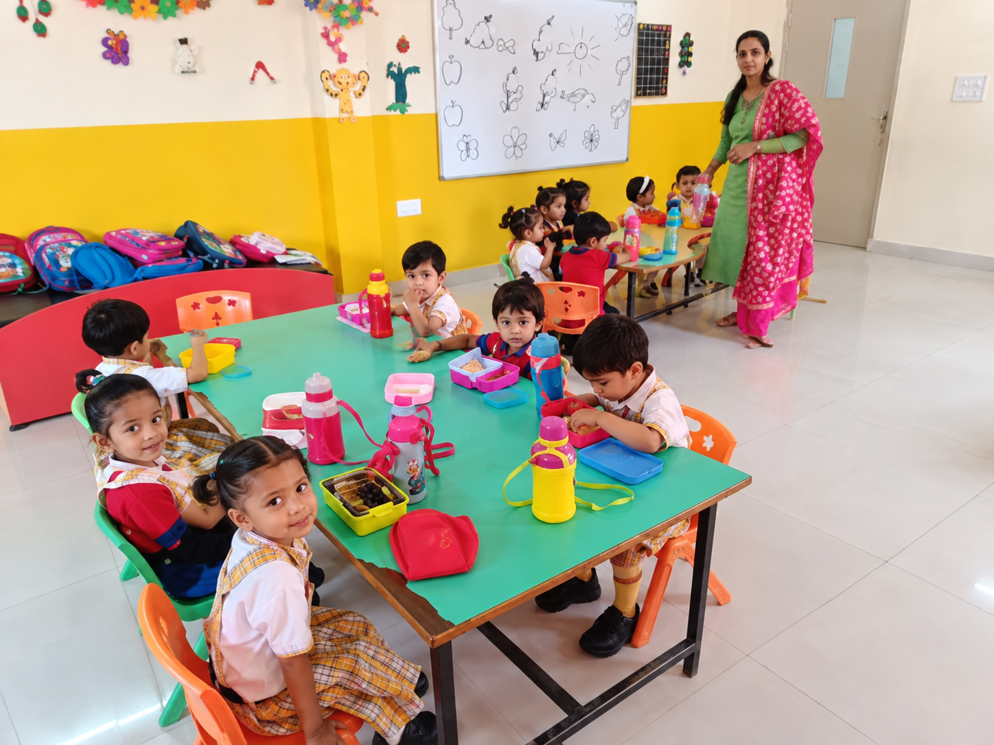 cheerful kindergarten lunchtime scene